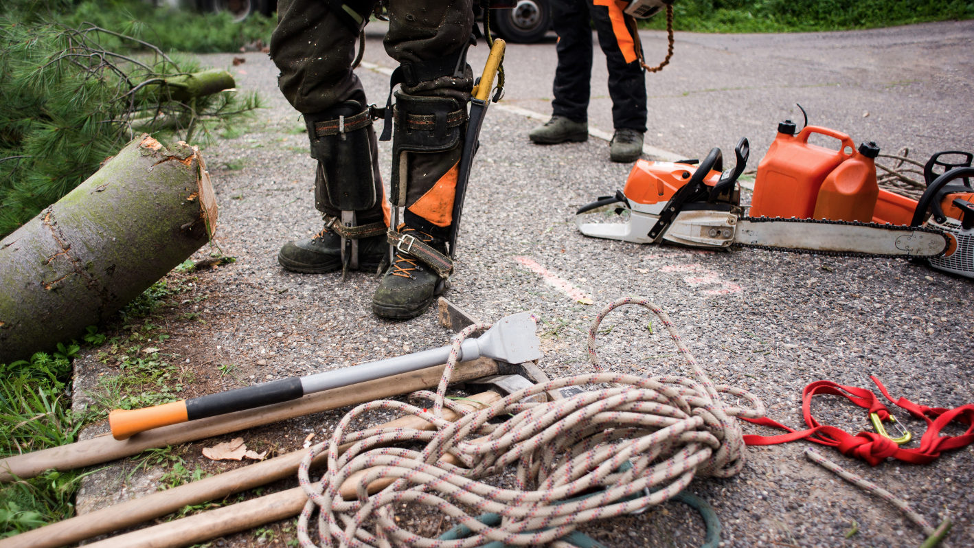 A man standing next to a pile of tools